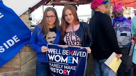 Jordan Bebout, left, marches with a friend at The Landing in Jacksonville, Florida.