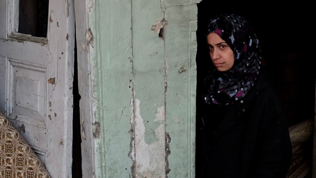 Ashwaq Abu Omran stands in the doorway of her house in the Old City of Mosul. The mother of two says ISIS militants forced the family out of their home and used it as a fighting position. Days later it was levelled in an airstrike. 
