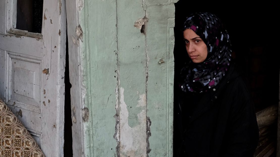 Ashwaq Abu Omran stands in the doorway of her house in the Old City of Mosul. The mother of two says ISIS militants forced the family out of their home and used it as a fighting position. Days later it was levelled in an airstrike.