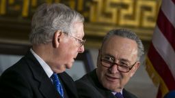 Senate Majority Leader Mitch McConnell (R-KY) (L) and Senate Minority Leader Chuck Schumer (D-NY) talk during the congressional Gold Medal ceremony for former Senate Majority Leader Bob Dole at the U.S. Capitol January 17, 2018 in Washington D.C. 