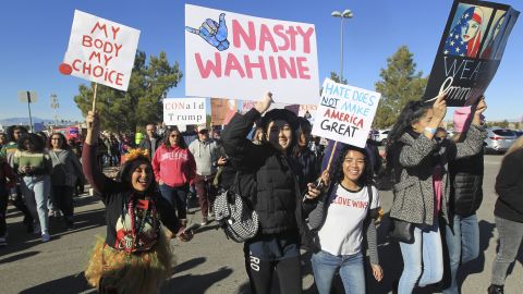 Protesters carry signs as they make their way to Sam Boyd Stadium for the Women's March rally on January 21, in Las Vegas, Nevada.