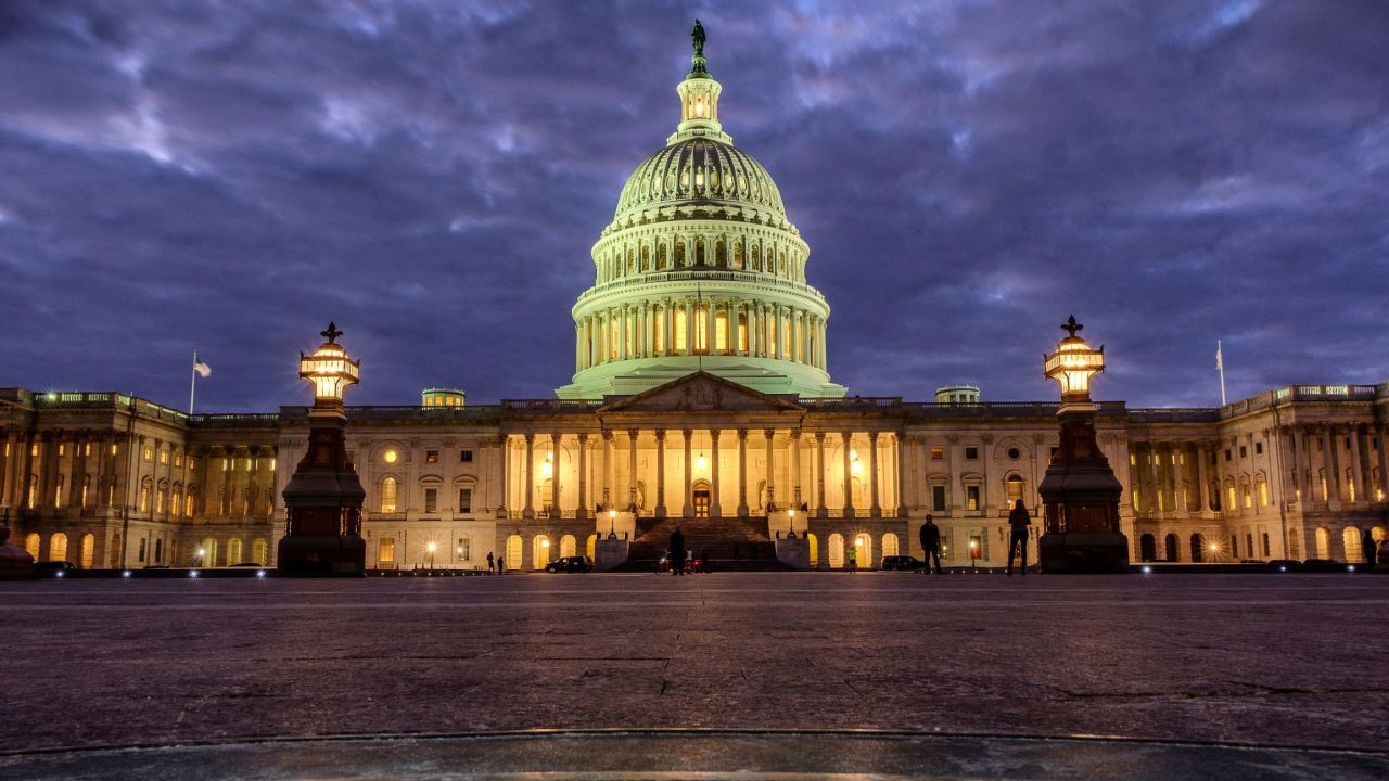 Lights shine inside the U.S. Capitol Building as night falls in Washington, Sunday, Jan. 21, 2018 and Congress continues to negotiate during the second day of the federal government shutdown. (AP Photo/J. David Ake)