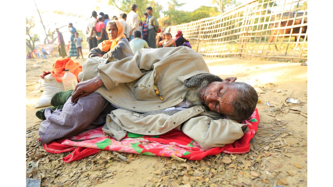 Dil Mohammad, 70,  takes a rest on the roadside near the Balukhali camp, Cox's Bazar on Saturday, January 20. He vomited after completing the treacherous  journey for Myanmar to Bangladesh.