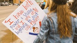 Olympic gymnast Aly Raisman's powerful statement during the sentencing of the doctor who molested became rallying cry for women. A woman carried this sign during Saturday's march in Indianapolis, Indiana.