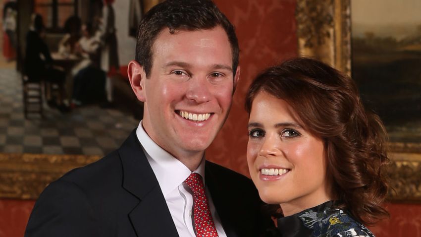 LONDON, ENGLAND -JANUARY 22: (EDITOR'S NOTE: Alternative crop of image #908732602) Princess Eugenie and Jack Brooksbank pose in the Picture Gallery at Buckingham Palace after they announced their engagement. Princess Eugenie wears a dress by Erdem, shoes by Jimmy Choo and a ring containing a padparadscha sapphire surrounded by diamonds on January 22, 2018 in London, England..  They are to marry at St George's Chapel in Windsor Castle in the autumn this year. (Photo by Jonathan Brady - WPA Pool/Getty Images)