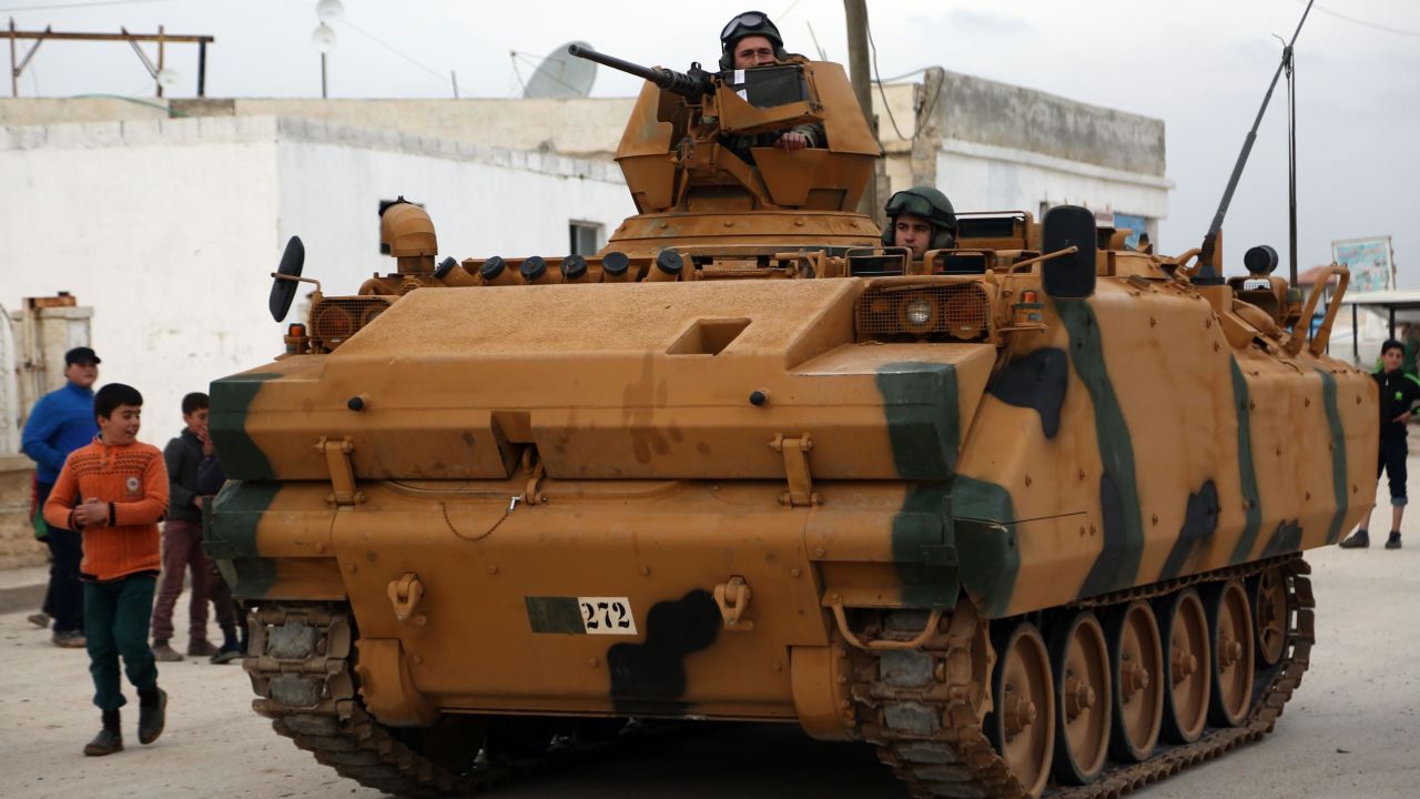 Turkish soldiers look through the hatches and turrets of an infantry fighting vehicle (IFV) as they pass through the Bab al-Salamah border crossing between Syria and Turkey in the north of Aleppo province, on January 21, 2018.
Turkish troops and tanks entered northern Syria on January 21 in an offensive aimed at ousting the Kurdish Peoples' Protection Units (YPG), which Ankara considers a terror group, from the Afrin region bordering Turkey. / AFP PHOTO / Nazeer al-Khatib        (Photo credit should read NAZEER AL-KHATIB/AFP/Getty Images)