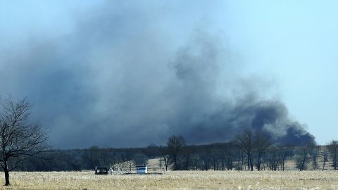 Smoke billows from the site of a gas well fire near Quinton, Oklahoma, early on January 22, 2018.