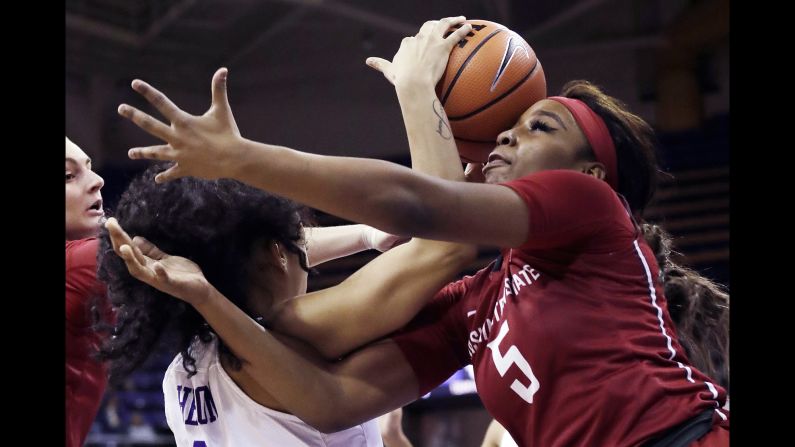 Washington State's Kayla Washington, right, misses as she reaches for a rebound with Washington's Mai-Loni Henson, left, in the first half of an NCAA college basketball game Sunday, January 21, in Seattle.