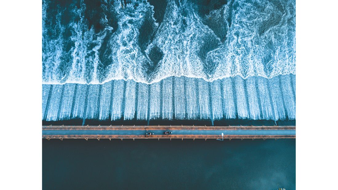 <strong>Winner "A View from Above" category -- Tom Sweetman (UK):</strong> In Chiang Mai, Thailand, Sweetman took this aerial photograph of the rushing river and the bridge below with a drone. The aerial category is new for 2017. "Some days you just capture the moment," says Sweetman.