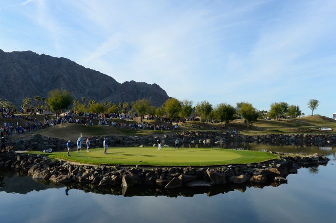 <strong>Island green:</strong> Players putt on the 17th hole of the TPC Stadium course at PGA West in La Quinta, California during the final round of the CareerBuilder Challenge on the PGA Tour.