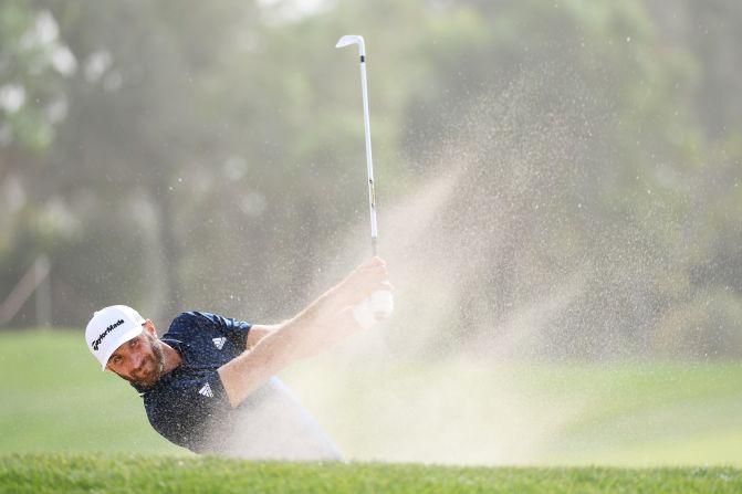 <strong>Sand man: </strong>World No.1 Dustin Johnson splashes out of a bunker during the final round of the Abu Dhabi HSBC Golf Championship.