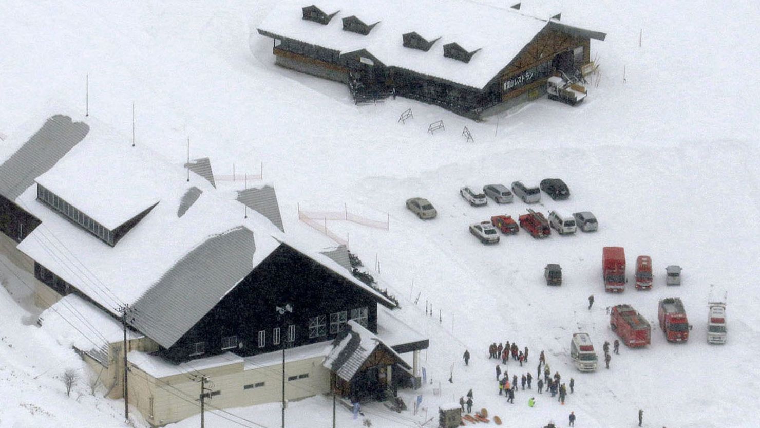 Fire trucks and ambulances are parked at a ski resort in Kusatsu, central Japan, after Mount Kusatsu-Shirane erupted Tuesday, January 23.