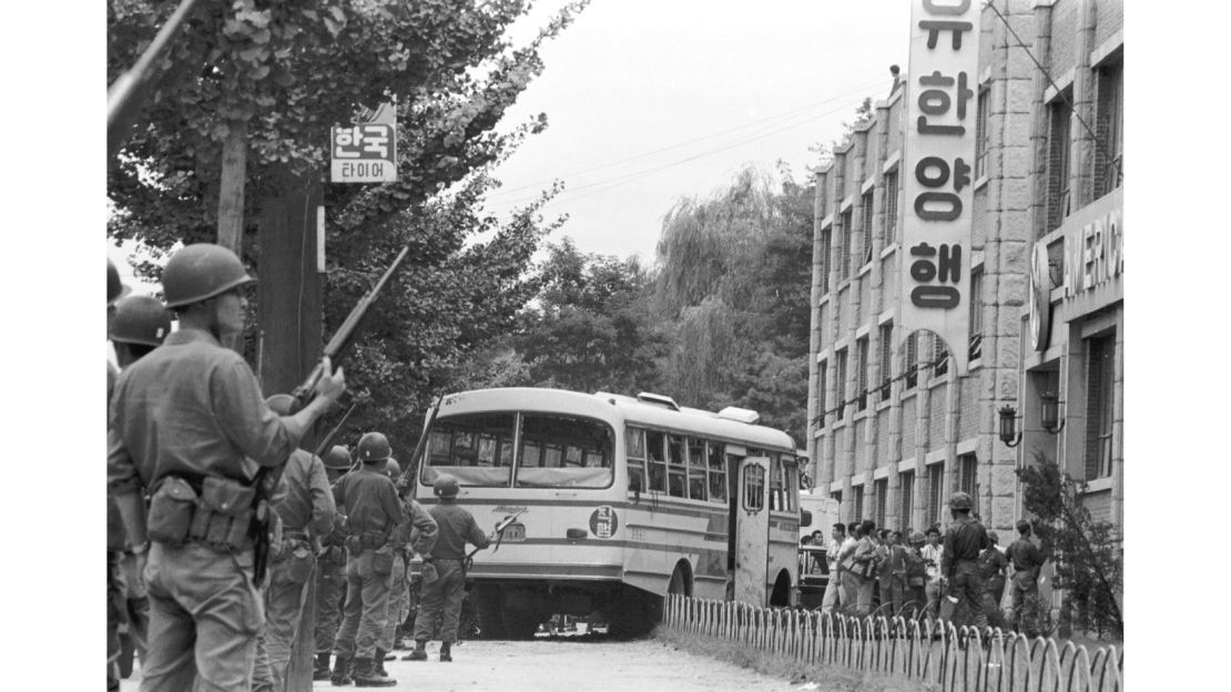 South Korean troops guard the bombed out remains for a bus hi-jacked by Unit 684 mutineers. 