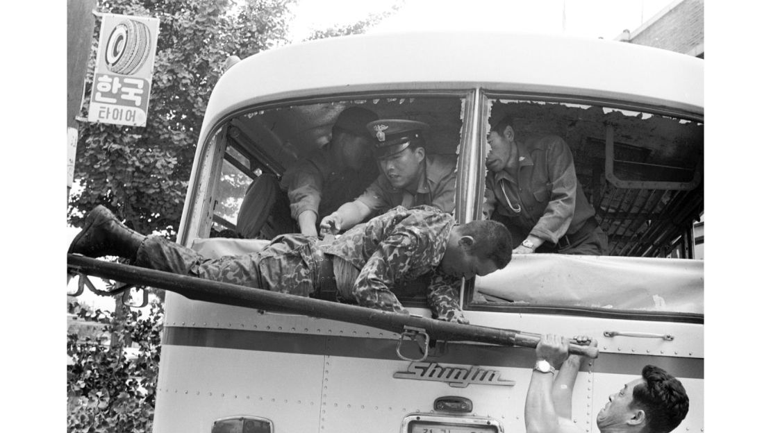 South Korean security forces carry one of the Unit 684  survivors in 1971. A 2006 Defense Ministry Truth Commision report revealed 20 mutineers were killed on board the bus. Four survivors were later executed.  