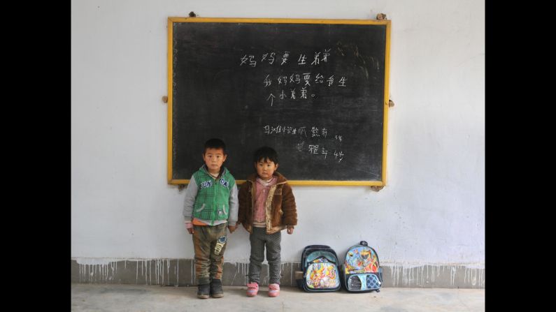 Zang Yixuan, 5, and his brother Zang Yaxuan, 4, at Ma Tan elementary school. Their messages read: "Mommy wants to have another boy." "My mommy wants to give me a little brother."