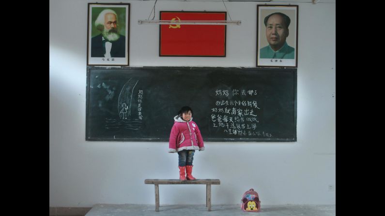 For more than a three years, photographer Ren Shichen has traveled around China taking portraits of the country's left-behind children. <br />Each child poses in a classroom with a message for their absent parents on the blackboard behind them.  Here, Gou Lingyu, 6, from Gaomiao Elementary School, Balipu County asks:  "Mommy, where did you go? Mommy left home when I was six months old. Daddy cooks for me every day and works in the field and takes me to school. On the left hand side of the board is written: "Mommy, are you coming back?" <br />