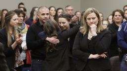 Former gymnast Rachael Denhollander, center, is hugged after giving her victim impact statement during the seventh day of Larry Nassar's sentencing hearing Wednesday, Jan. 24, 2018, in Lansing, Mich. At right is Assistant Attorney General Angela Povilaitis. Nassar has admitted sexually assaulting athletes when he was employed by Michigan State University and USA Gymnastics, which is the sport's national governing organization and trains Olympians.