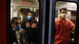 MEXICO CITY - APRIL 28: People wear surgical masks as they ride the subway on April 28, 2009 in Mexico City, Mexico. Reports indicate that most people confirmed with the new swine flu were infected in Mexico, where the number of deaths blamed on the virus has surpassed 150. (Photo by Joe Raedle/Getty Images)