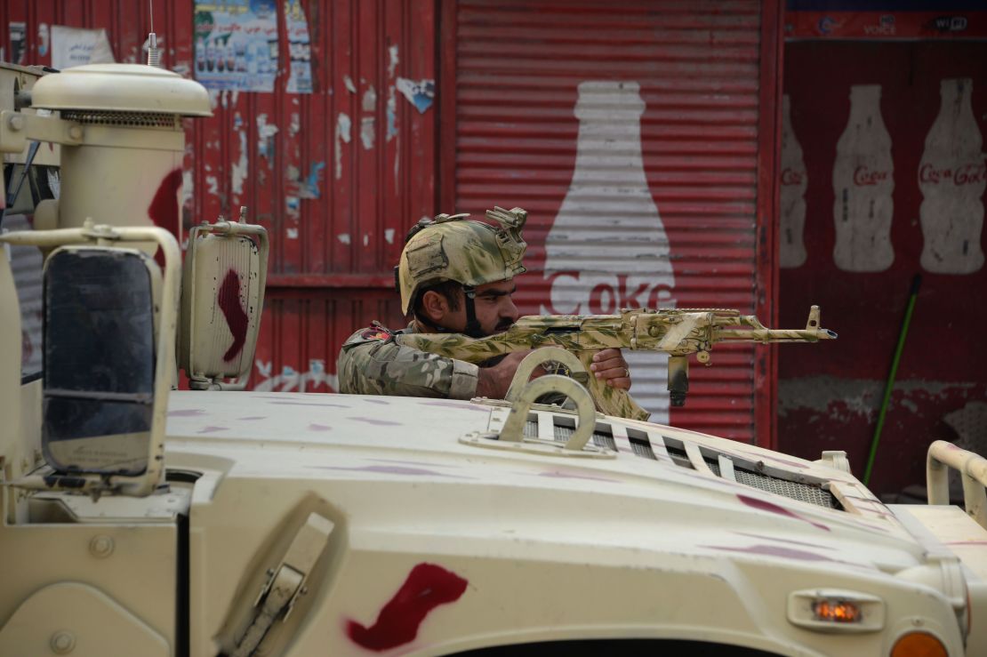 An Afghan army soldier takes a position Wednesday near the Save the Children office in Jalalabad. 