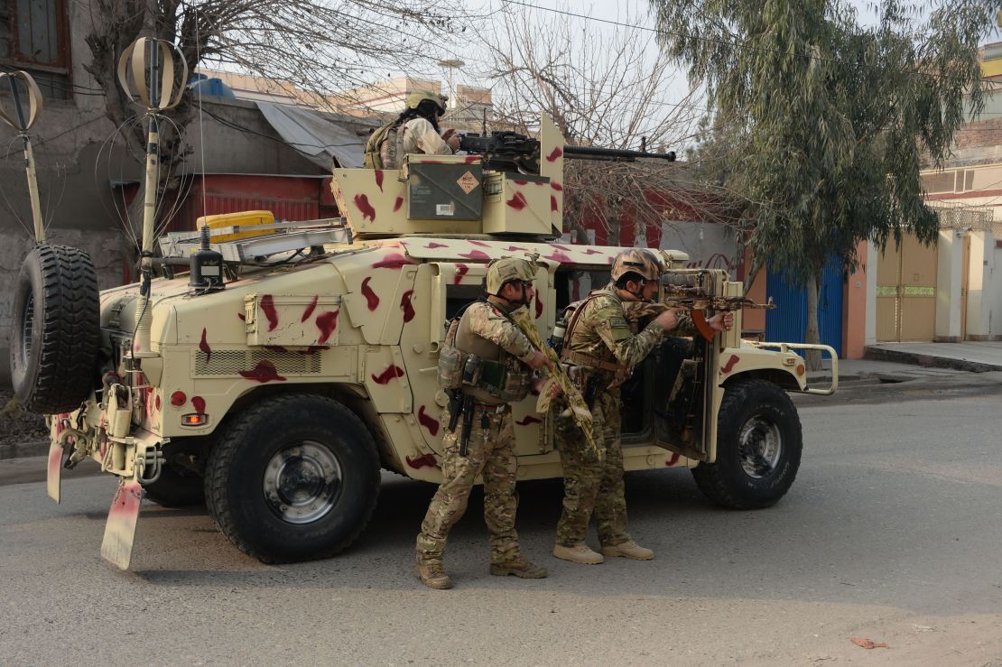 Soldiers stand behind a vehicle Wednesday in Jalalabad.