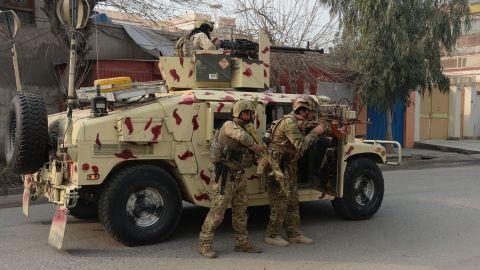 Soldiers stand behind a vehicle Wednesday in Jalalabad.