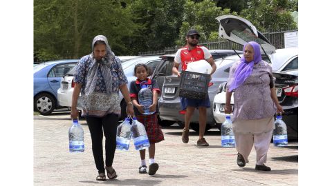 People carry water collected from a natural spring earlier this week in Cape Town.