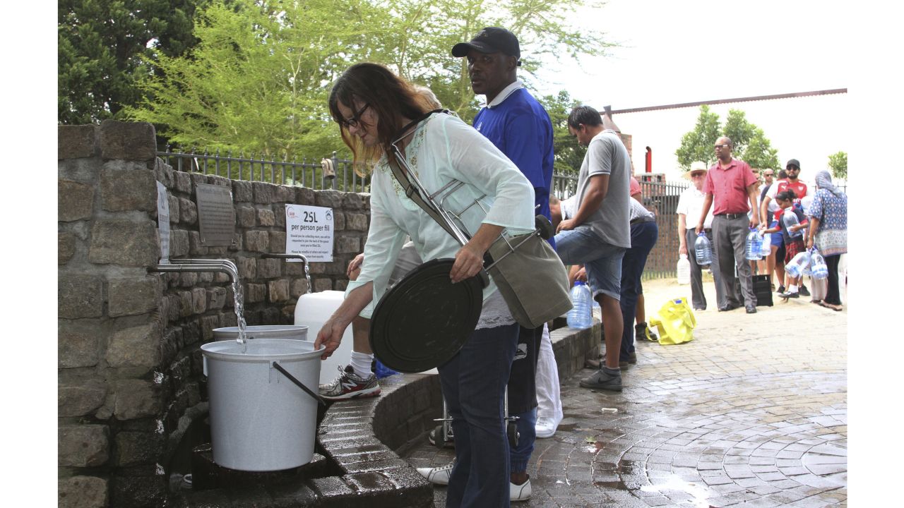 People queue to collect water from a natural spring in Cape Town, South Africa, Monday, Jan 22, 2018 as the city suffers from one of the worst droughts in recent history. Officials are looking to combat the drought, saying it was looking more likely that it will have to turn off most taps on "Day Zero," or April 21 stating that 60 percent of residents are "callously" using more than the current limit and that the city will fine households that use too much water. (AP Photo/Anwa Essop)