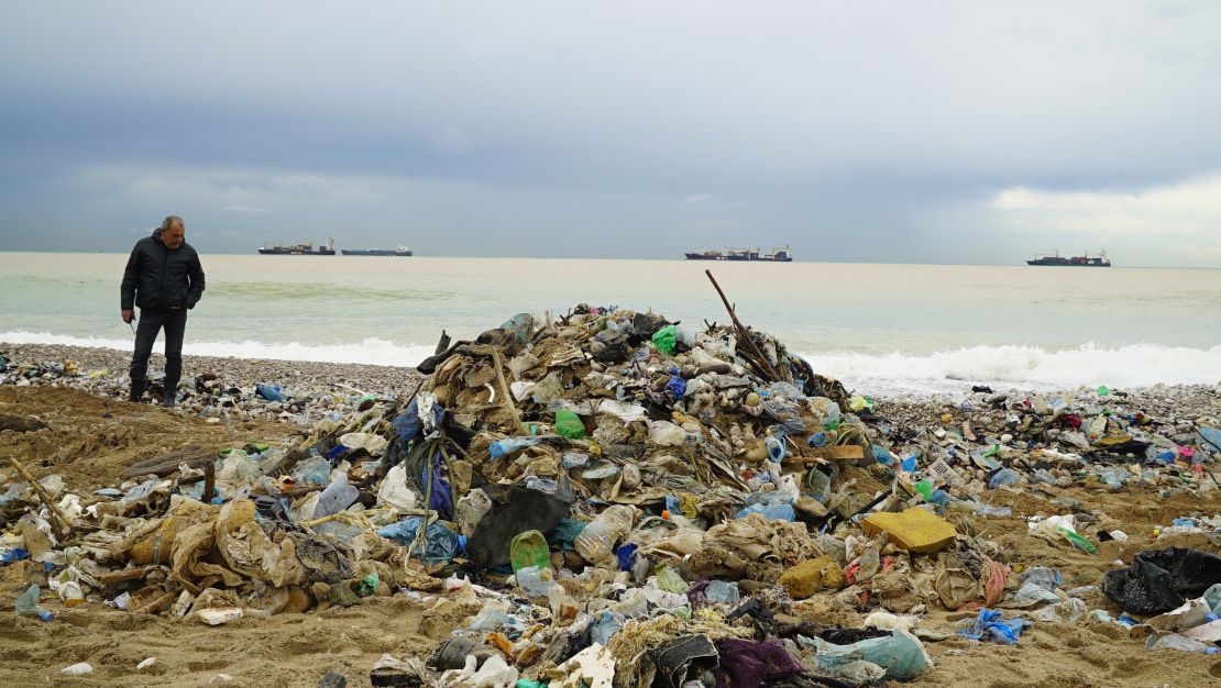 A garbage collector overses a clean-up one of north Beirut's trash-infested beaches.