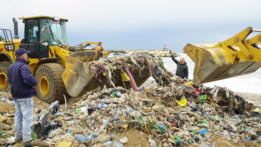 Bulldozers at a trash-infested beach in north Beirut help to clear the garbage.