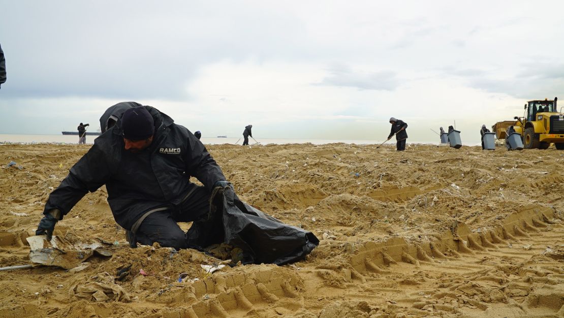 One of many garbage collectors dispatched to Lebanon's beaches after jarring images of trash-strewn shores circulated on social media.