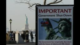 NEW YORK, NY - JANUARY 21: A Shutdown placard is seen at the entrance of the Liberty State ferry terminal as people look on in Battery Park on January 21, 2018 in New York City. The iconic landmark remains closed as part of the US government shutdown now entering its second full day after coming into effect at midnight on Friday after senators failed to pass a new federal spending bill. (Photo by Eduardo Munoz Alvarez/Getty Images)