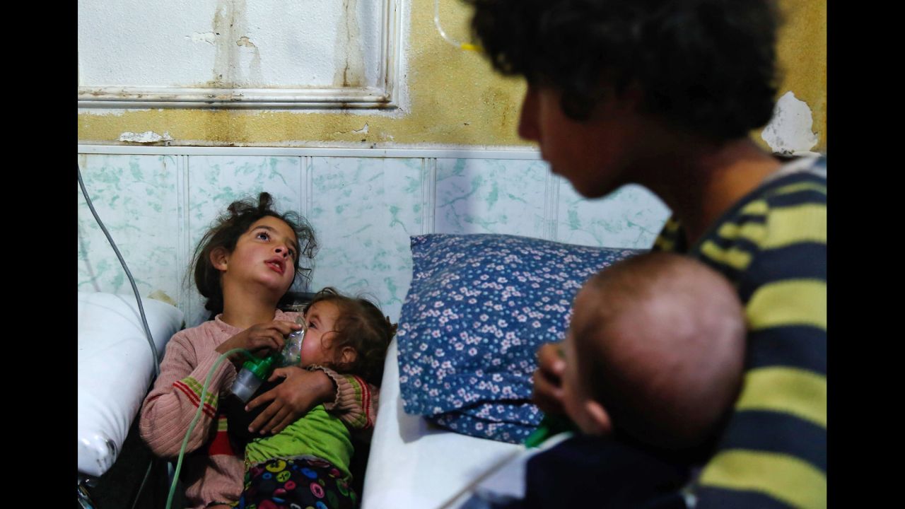 A Syrian girl holds an oxygen mask over the face of an infant at a makeshift hospital on Monday, January 22, following a reported gas attack in the Douma suburb of Damascus, Syria. Speaking in Paris about the reported attack the following day, <a href="http://www.cnn.com/2018/01/23/politics/tillerson-russia-syria-chemical-attacks/index.html" target="_blank">US Secretary of State Rex Tillerson said</a> more than 20 civilians, most of them children, "were victims of an apparent chlorine gas attack." He also criticized Russia for its failure to hold the regime of Syrian President Bashar al-Assad accountable for using chemical weapons against his people.