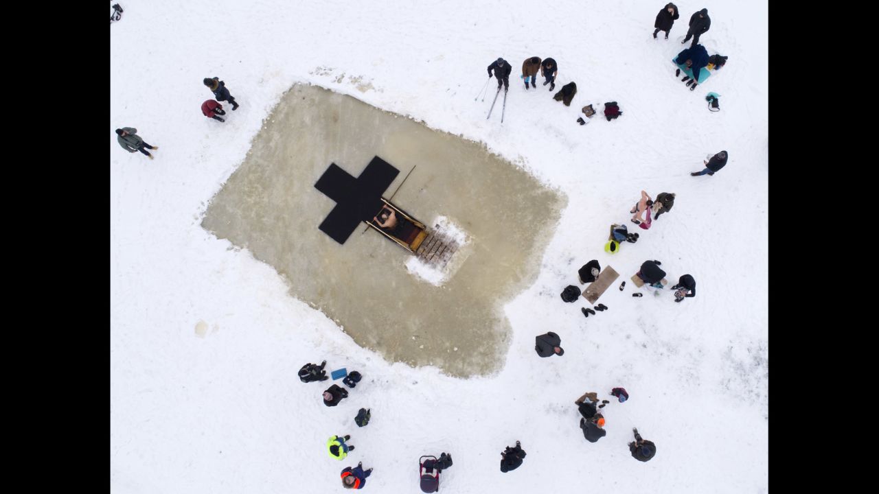 Members of the Russian Orthodox Church mark the feast of the Epiphany at an icy lake in Orlino village, about 70 kilometers (43 miles) south of St. Petersburg, Russia, on Friday, January 19. <a href="http://www.cnn.com/2018/01/19/europe/putin-icy-dip-intl/index.html" target="_blank">Russian President Vladimir Putin also took an icy plunge</a> in Lake Seliger, north of Moscow, as part of the traditional Orthodox Christian ritual which commemorates the baptism of Jesus.