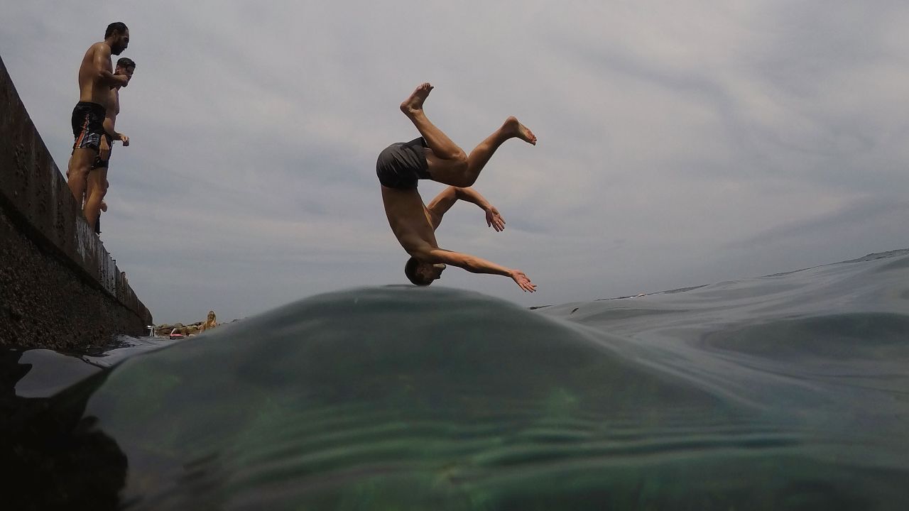 A boy dives into the ocean in the suburb of Clovelly in Sydney, Australia, on Monday, January 22.