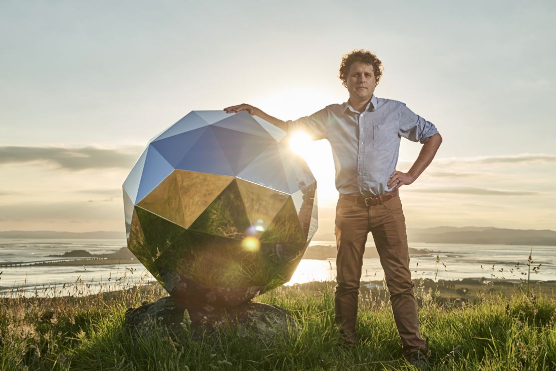 Rocket Lab founder Peter Beck poses next to the satellite prior to launch. 