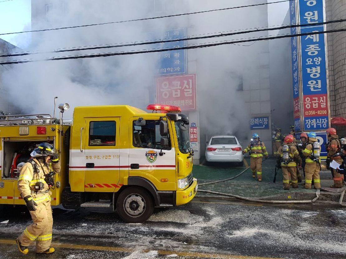 Firefighters work to put out the blaze Friday as smoke billows from the Sejong Hospital.