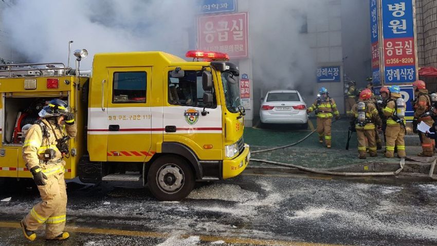 Firefighters work as smoke billows from a hospital in Miryang, South Korea, Friday, Jan. 26, 2018. The hospital fire causes scores of casualties and injuries, according to a fire agency official. (National Fire Agency/Yonhap via AP)
