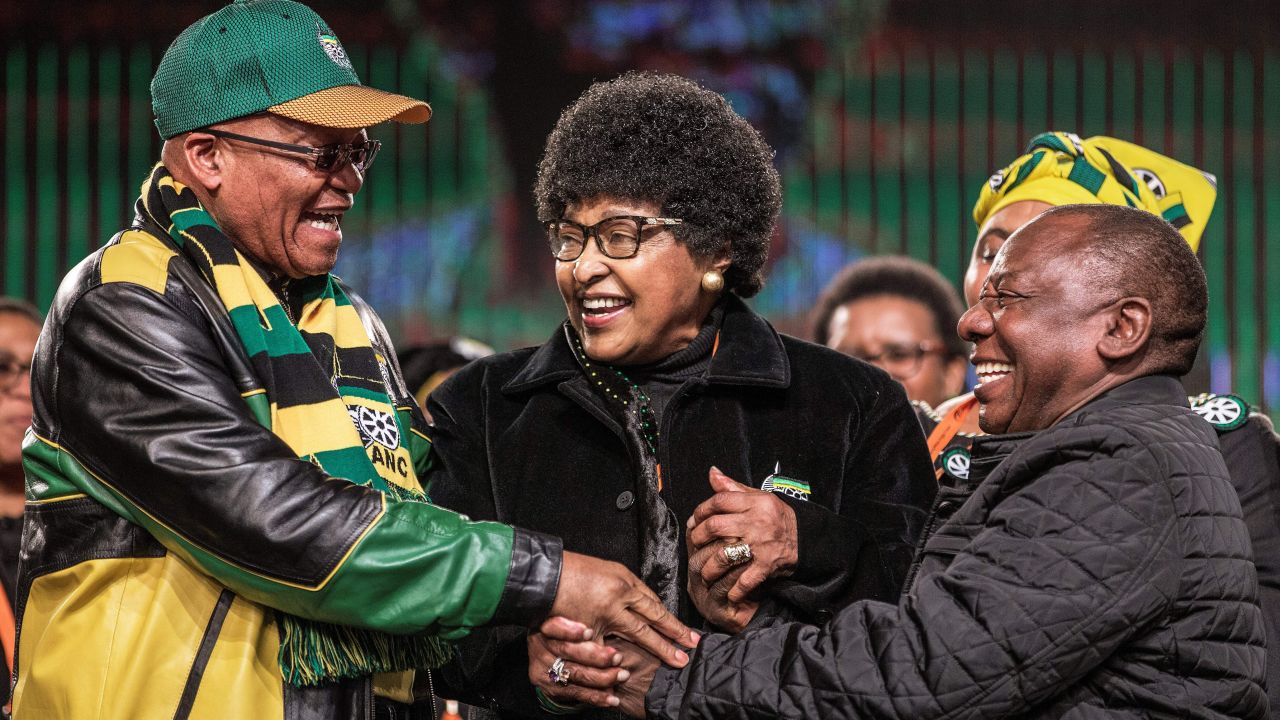 Madikizela-Mandela joins the hands of South African President <a href="http://www.cnn.com/2018/02/08/africa/gallery/jacob-zuma-career/index.html" target="_blank">Jacob Zuma, </a>left, and Deputy President Cyril Ramaphosa during an African National Congress policy conference in 2017.