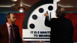 Robert Rosner, chairman of the Bulletin of the Atomic Scientists, right, joined by Bulletin of the Atomic Scientists member Lawrence Krauss, left, moves the minute hand of the Doomsday Clock to two minutes to midnight during a news conference at the National Press Club in Washington, Thursday, Jan. 25, 2018. ( AP Photo/Carolyn Kaster)