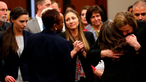 Rachael Denhollander and Kyle Stephens, two survivors of Larry Nassar's abuse, and others embrace at his sentencing. 