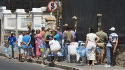 South Africa Western Cape Province. People queue to collect drinking water from pipes fed by an underground spring, in St. James, about 25km from the city centre on 26 January, 2017.  Low rainfall in the previous two rainy season means that the Western Cape Province is in the grips of the worst drought in a century, with taps in the Cape Town metropole estimated to run dry in April 2018, unless rains come earlier than they usually do. Dams in this area are 30% full, with the last 10% not accessable.Photo by Rodger Bosch for CNNwww.rodgerbosch.co.za+27 82 894 1417dodge@netactive.co.za