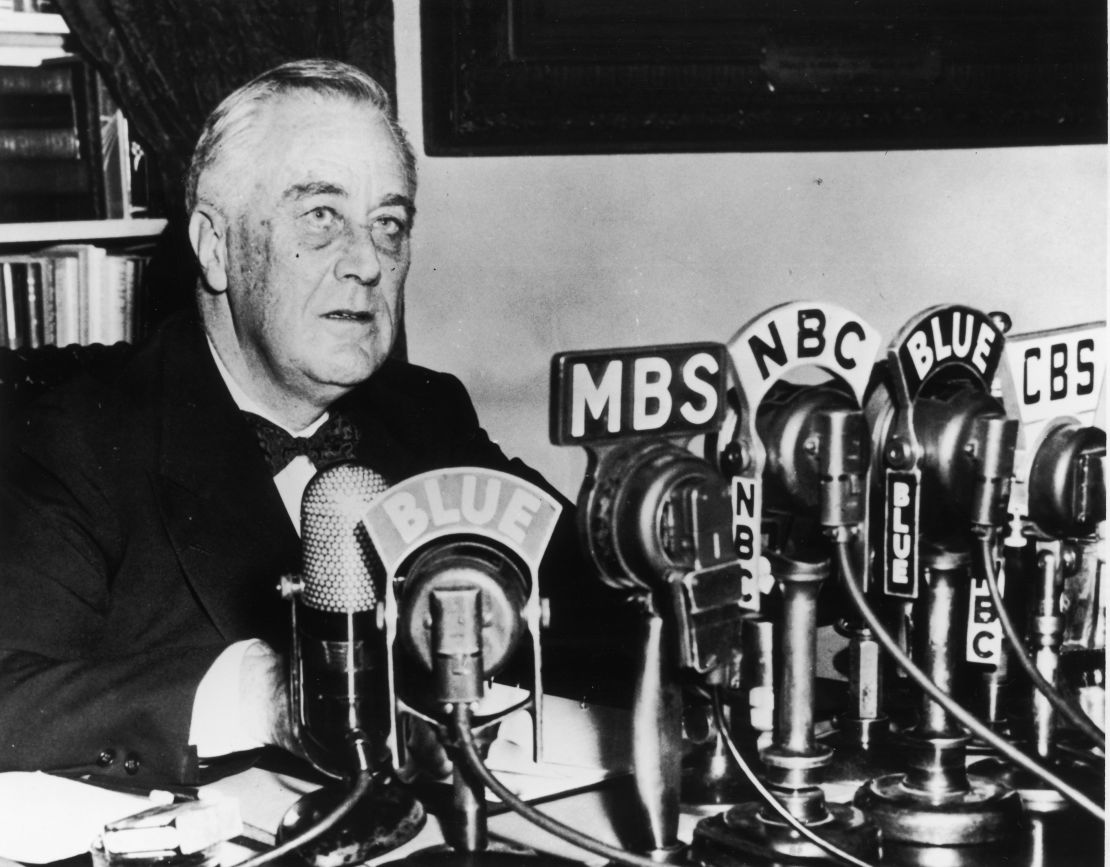 President Franklin D. Roosevelt seated in front of a number of television and radio station microphones, circa 1940s. 