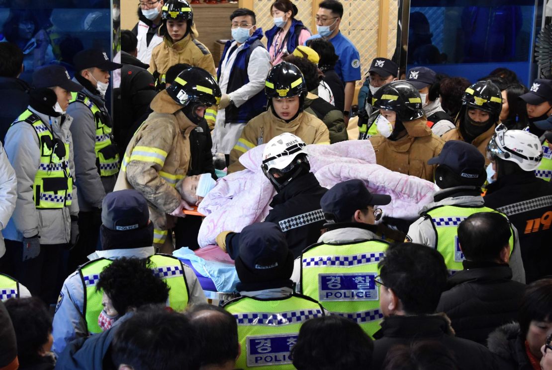 Rescue workers remove a survivor from the hospital fire Friday in Miryang, South Korea. 