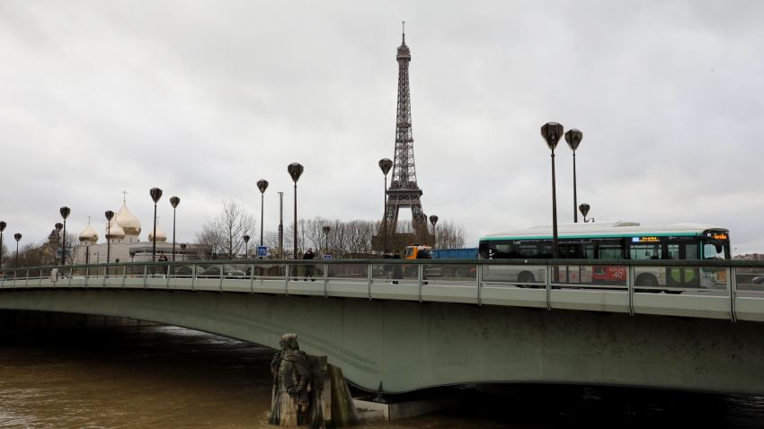 Traffic moves across the Pont D'Alma bridge past the Eiffel Tower and the Holy Trinity Cathedral, as the Zouave statue stands partially submerged   after the River Seine burst its banks in Paris on January 24, 2018.  / AFP PHOTO / ludovic MARIN        (Photo credit should read LUDOVIC MARIN/AFP/Getty Images)