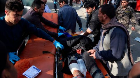 An injured man is moved to a stretcher outside a Kabul hospital following Saturday's attack.