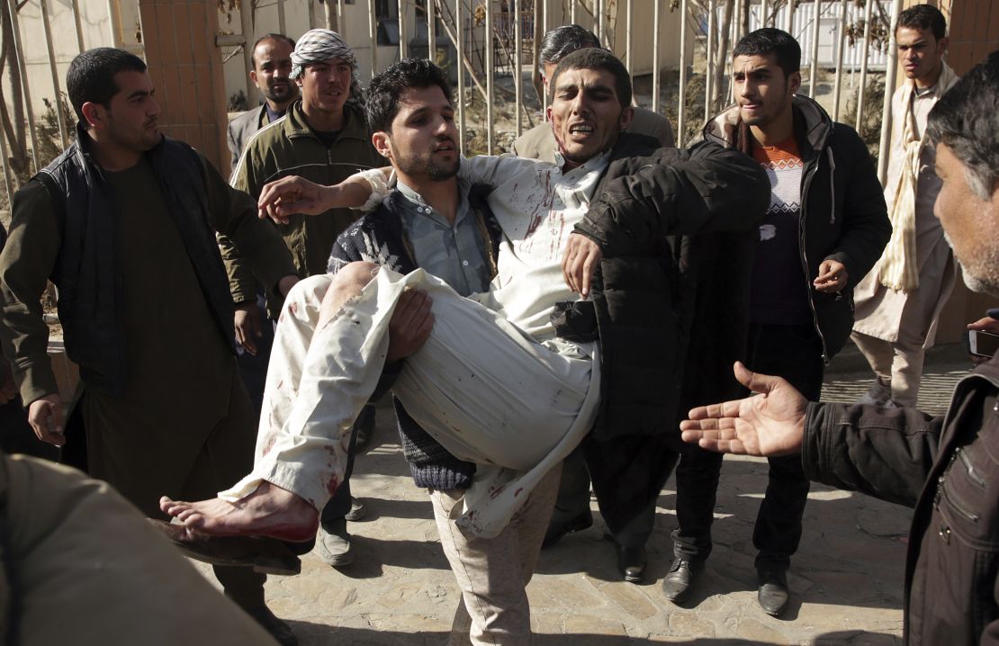 An injured man is carried away from the site of a deadly suicide attack Saturday in Kabul.