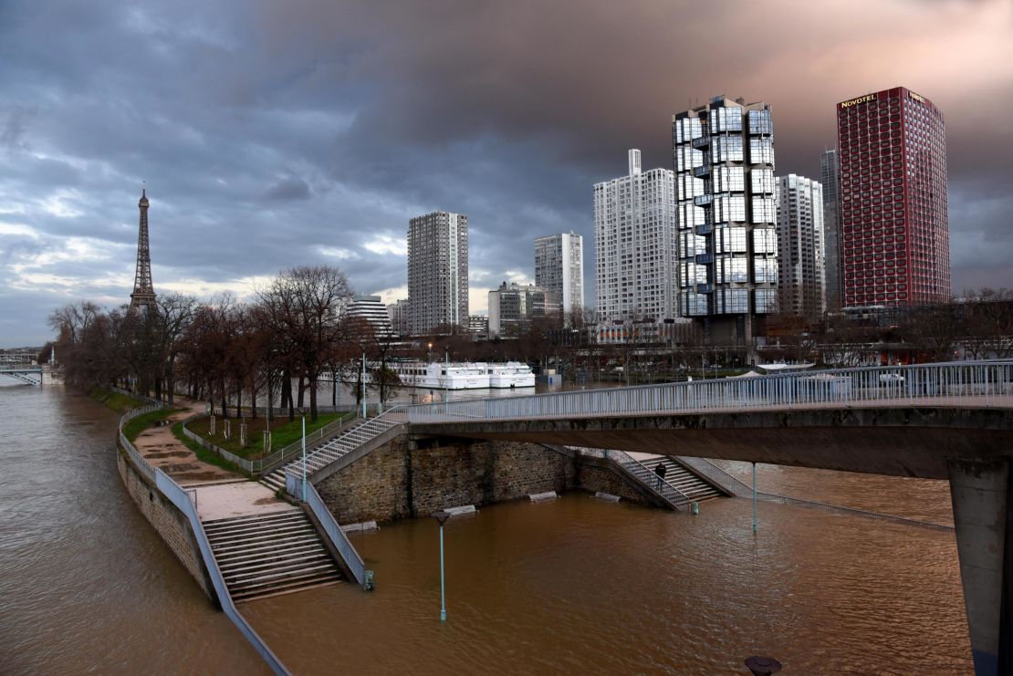 Views of the swollen Seine on Saturday in Paris, with the Eiffel Tower in the background at bottom.