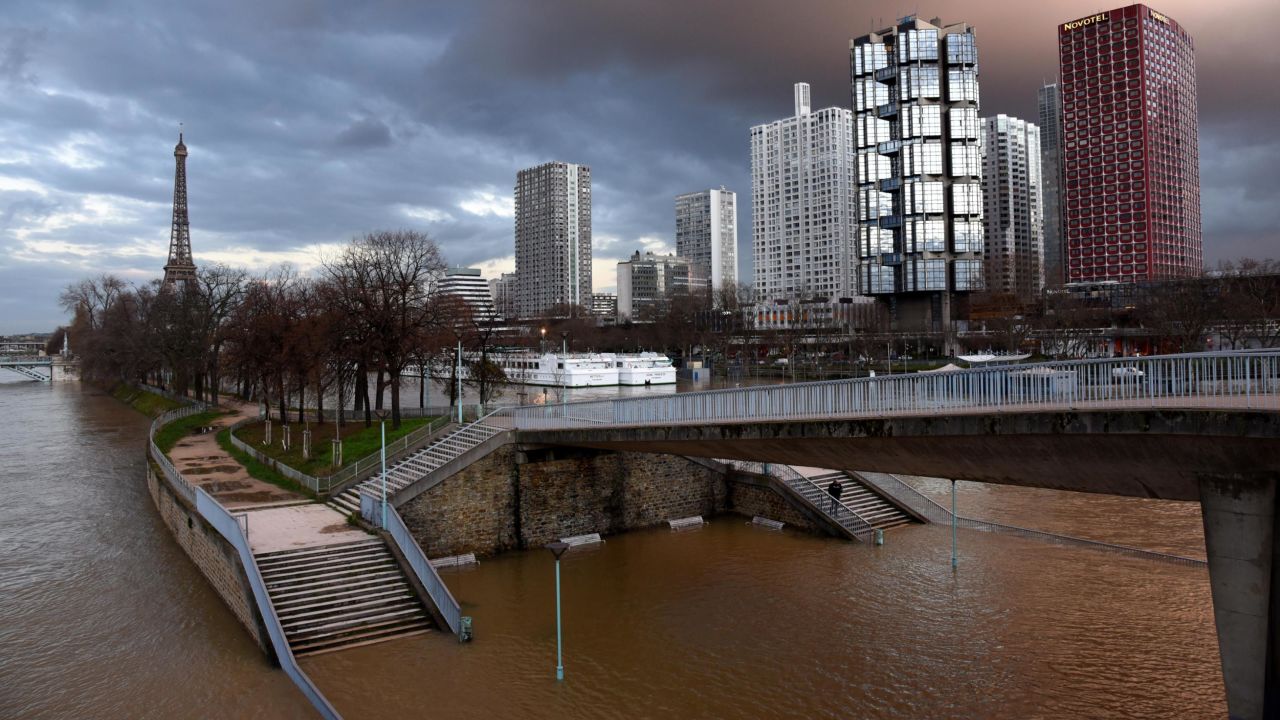 Views of the swollen Seine on Saturday in Paris, with the Eiffel Tower in the background at bottom.