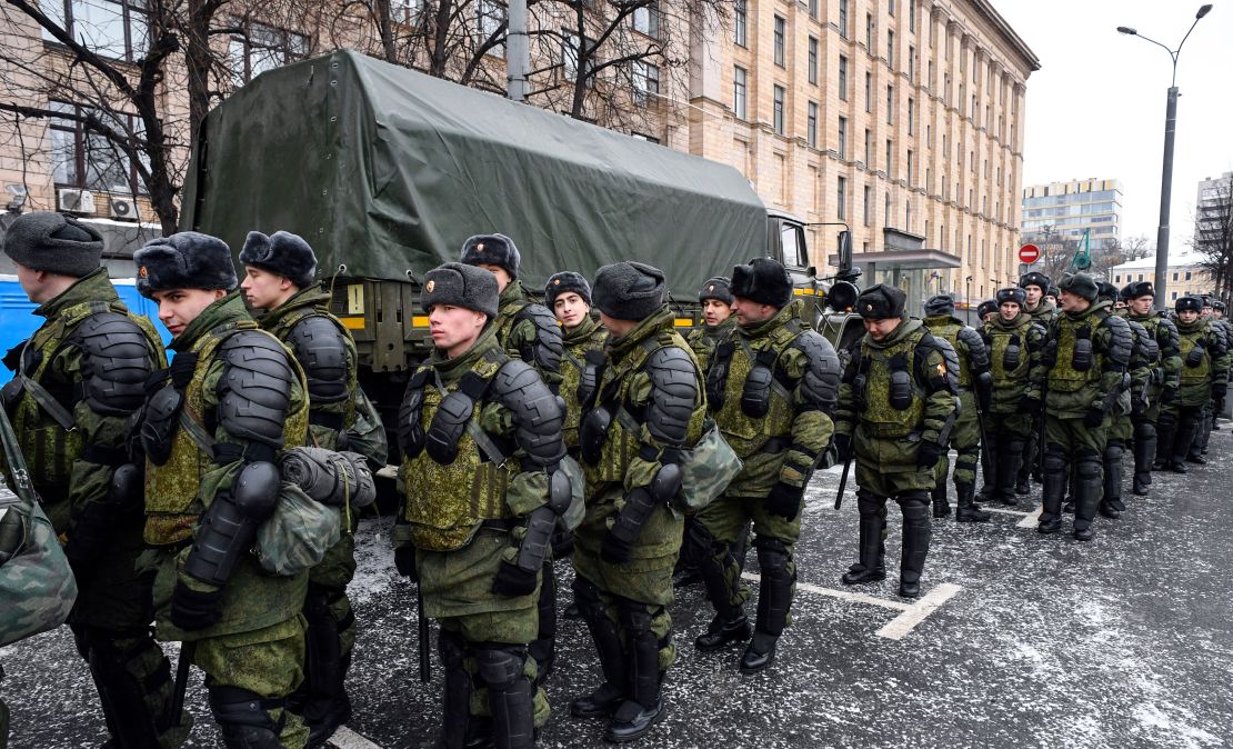 Service members gather at Triumfalnaya Square ahead of an opposition rally calling for a boycott of March 18 presidential elections.