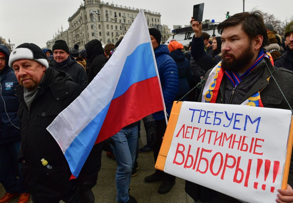 One protester in Moscow brandishes a placard saying: "Demand lawful election." 